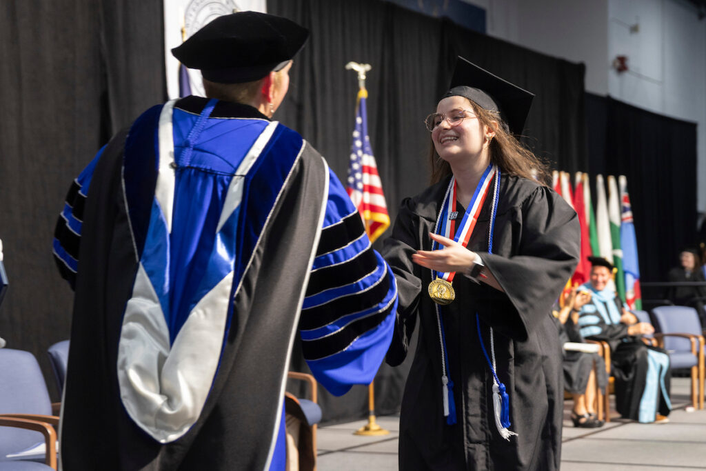 Students receive diplomas and celebrate with friends and family.