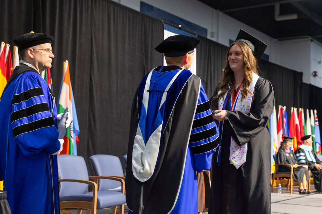Students receive diplomas and celebrate with friends and family.