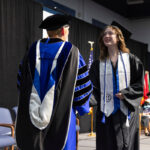 Students receive diplomas and celebrate with friends and family.